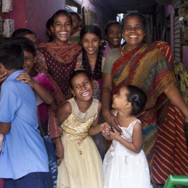 A group of women and children smiling.